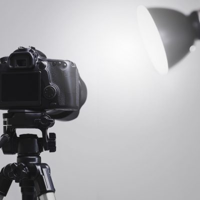 DSLR camera mounted on a tripod in a photography studio setup