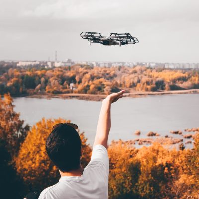 Man launches quadrocopter rear view