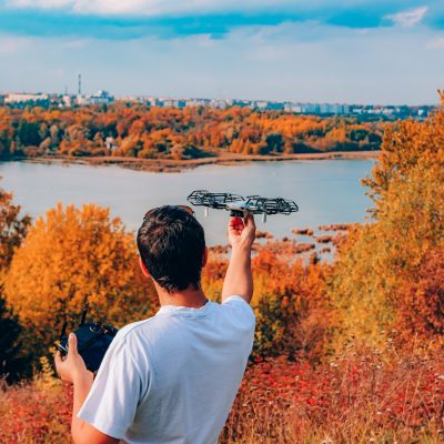Man launches quadrocopter rear view