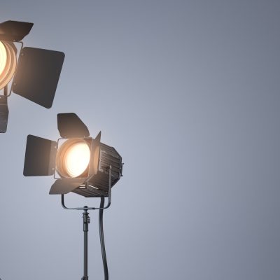 Spotlight studio lighting equipment for photography or videography on grey backgound.
